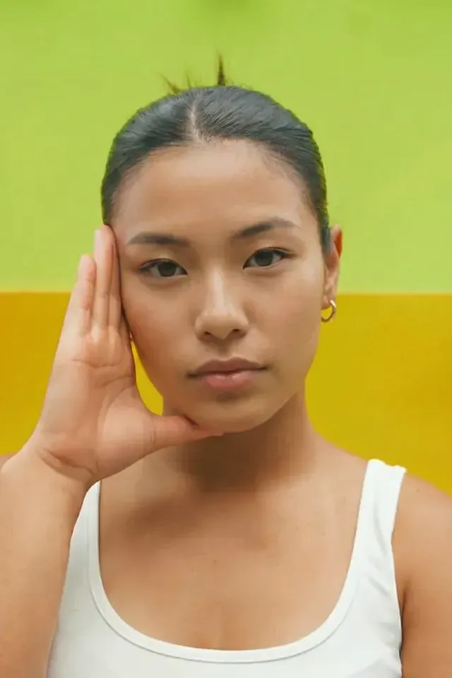 The same photo after AI face replacement, with a consistent synthetic face and unchanged pose and lighting