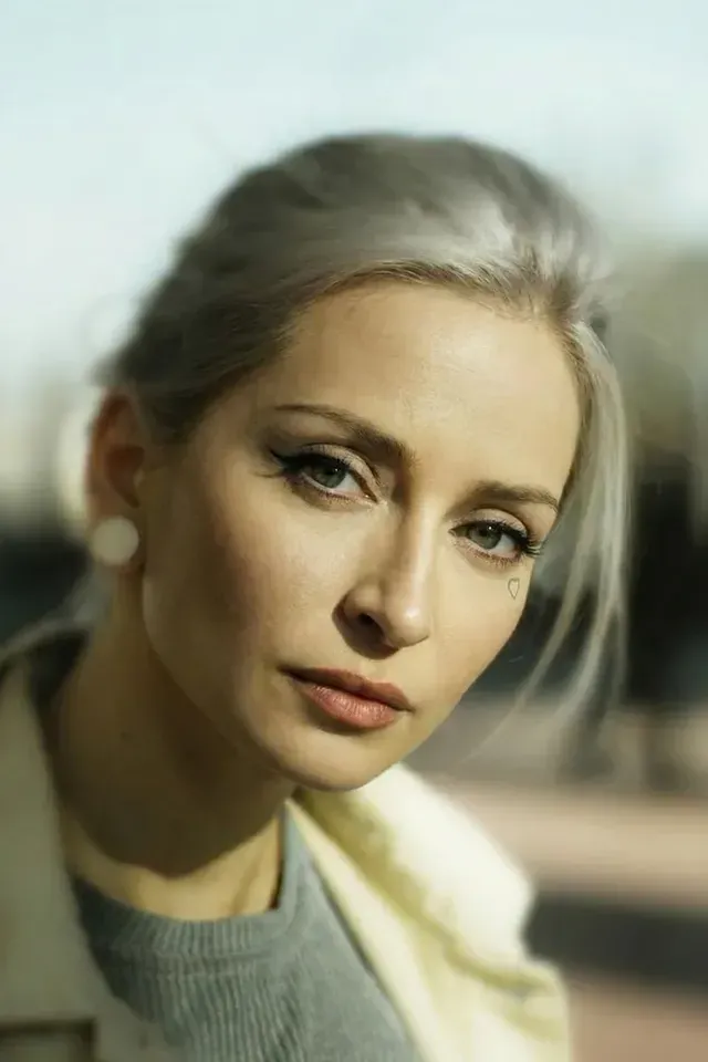 The same photo after AI face replacement, with a synthetic face and unchanged pose and lighting